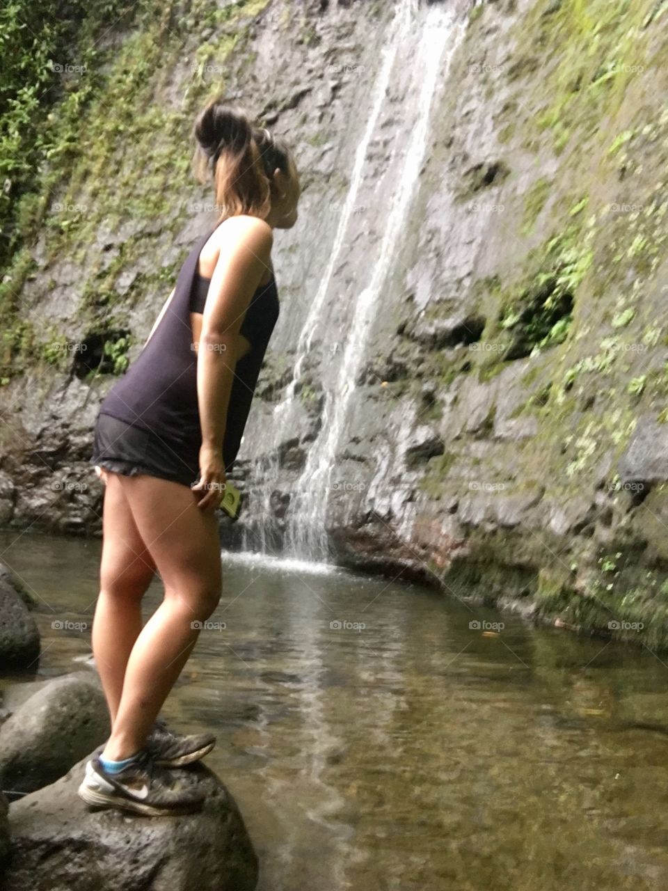 Looking up in awe at the beauty of nature, enjoying the waterfall at Manoa Falls, Oahu Hawai’i 