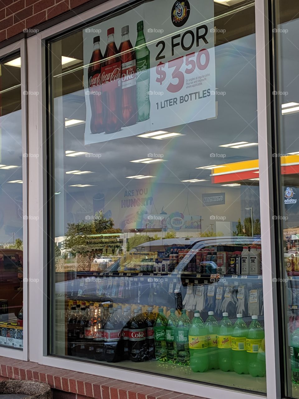 rainbow inside holiday oil shell Sinclair gas station window reflection