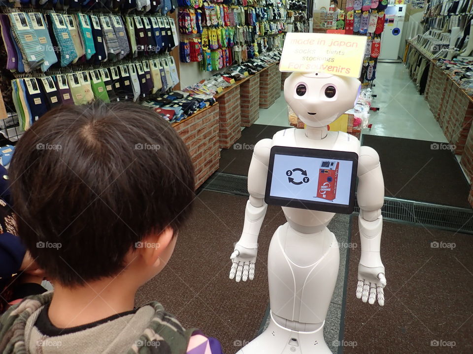 Child playing with robot