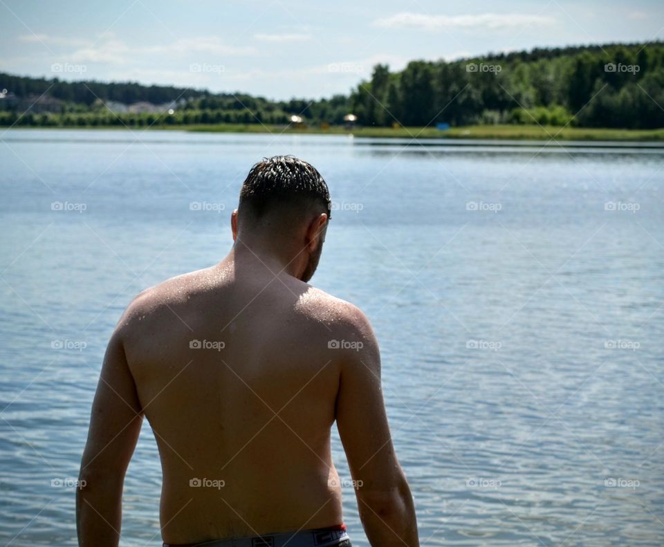 men on a lake swimming summer vacation