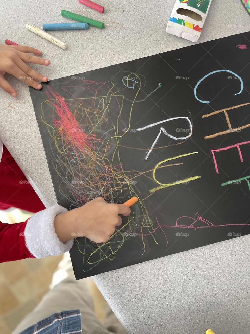 Child draws with chalk, making art with chalk, toddler art, mother watches daughter draw with chalk, mother’s perspective, getting creative 