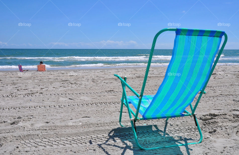Summer day at the beach. Beach chair.