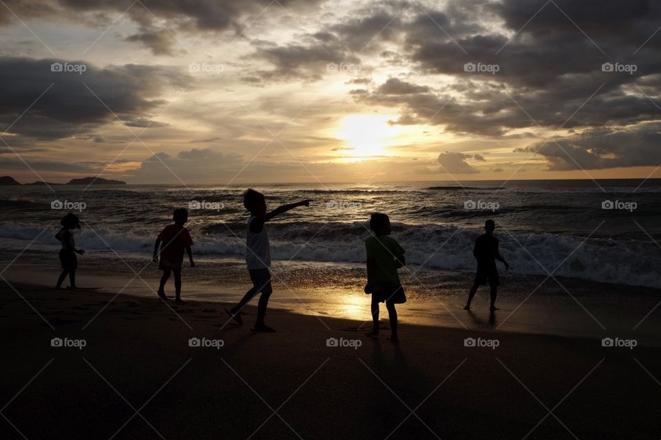 Kids playing at sunset 