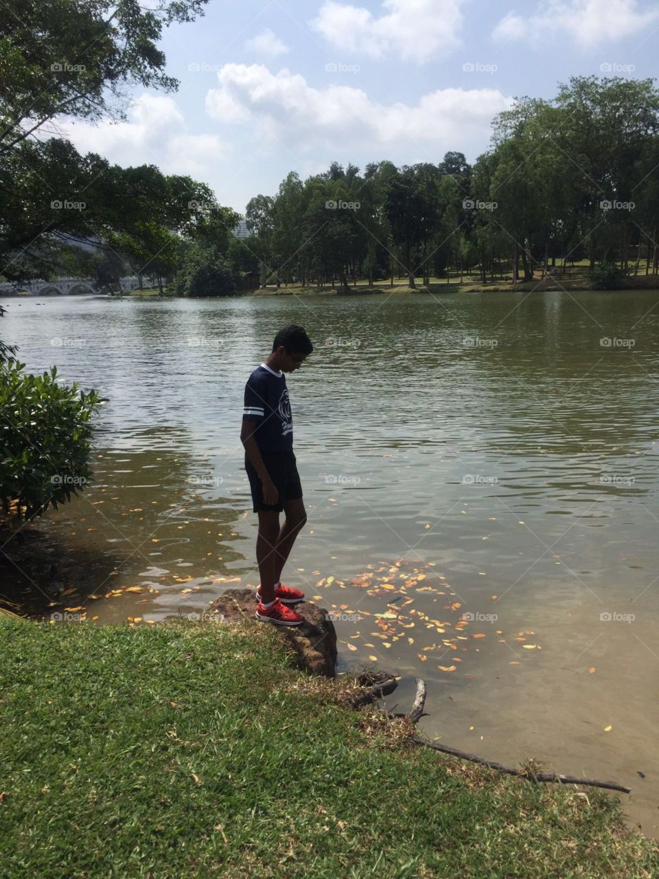 A boy looking at the lake