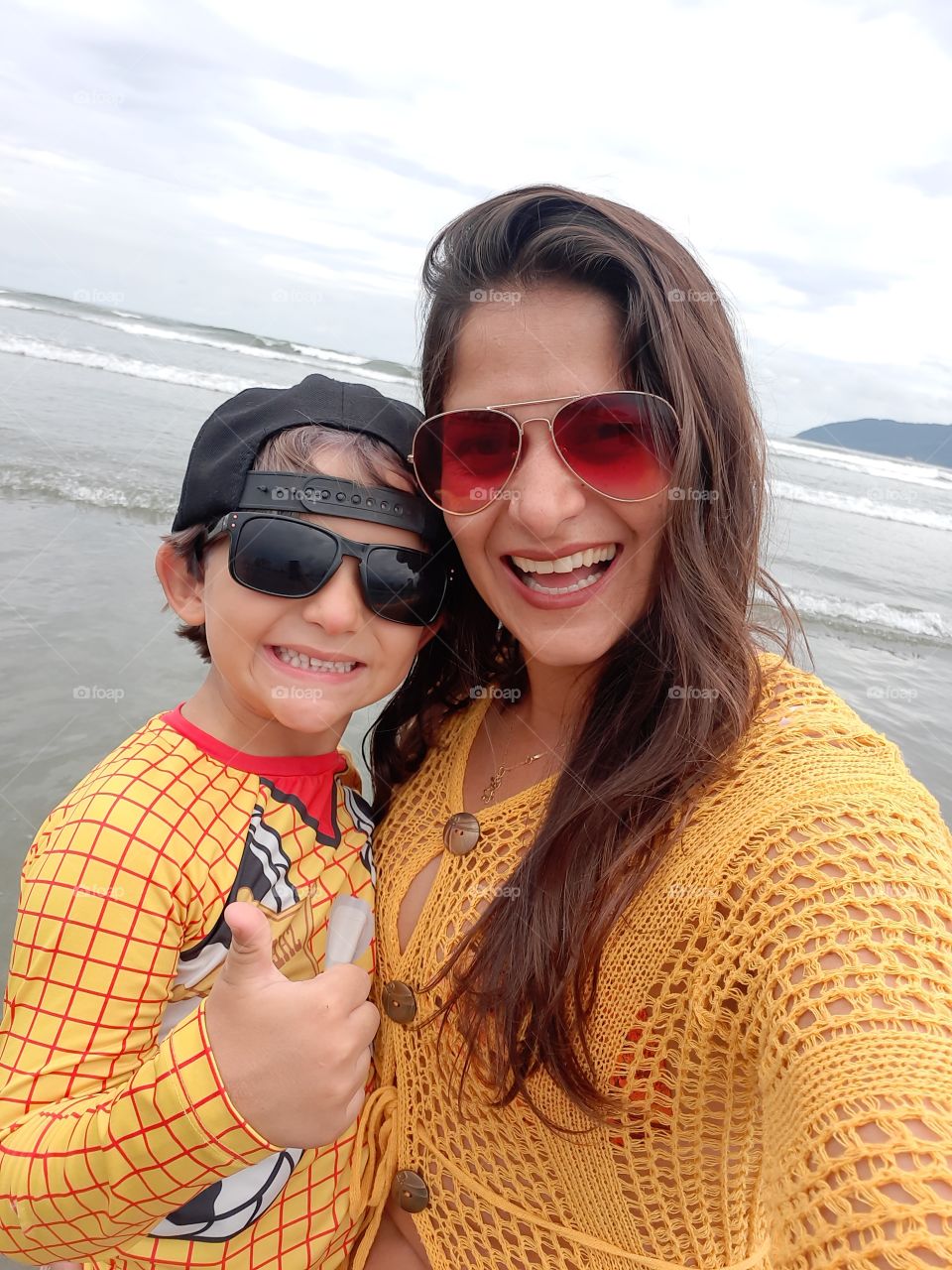 smiling woman and son on the beach in Santos