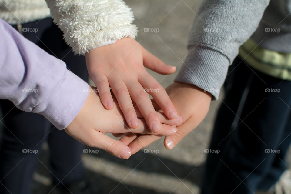 kids hands on top of each other