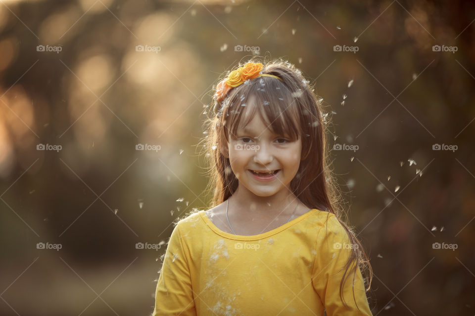 Little girl in yellow dress outdoor portrait at sunset 