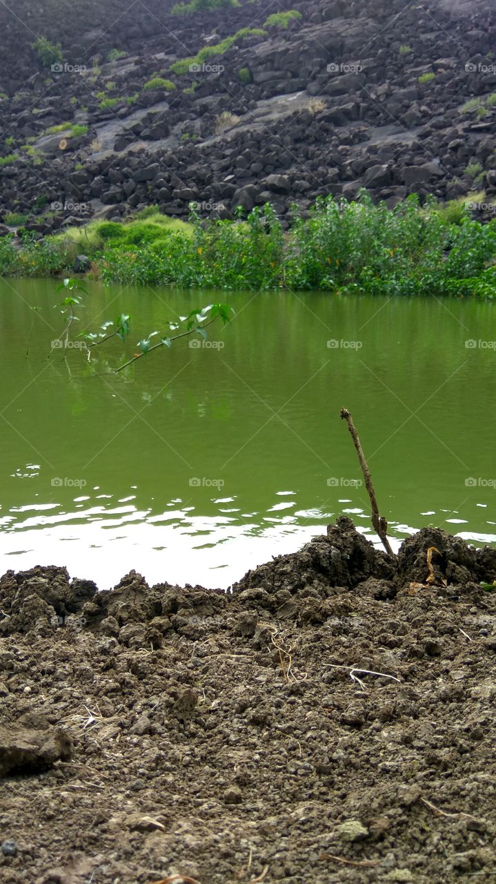 reflection of hill in water shade