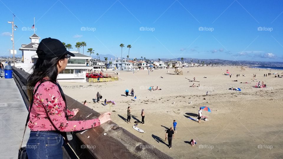 fashionable woman looking out the sea view of the beach waterfront