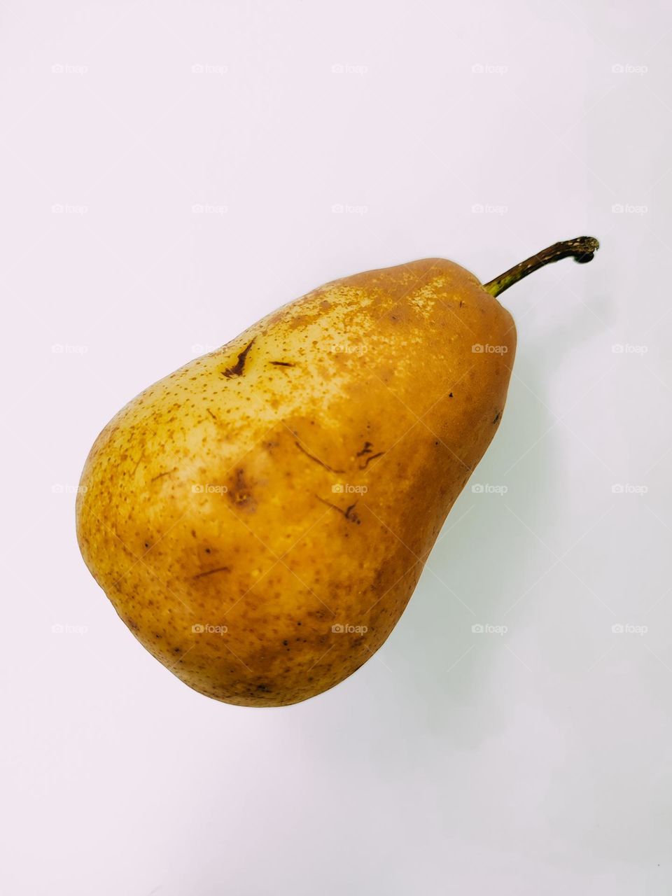 Ripe brown yellow pear fruit close up isolated top view