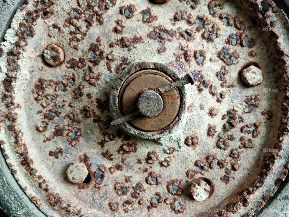Rusted pattern on cart wheels.