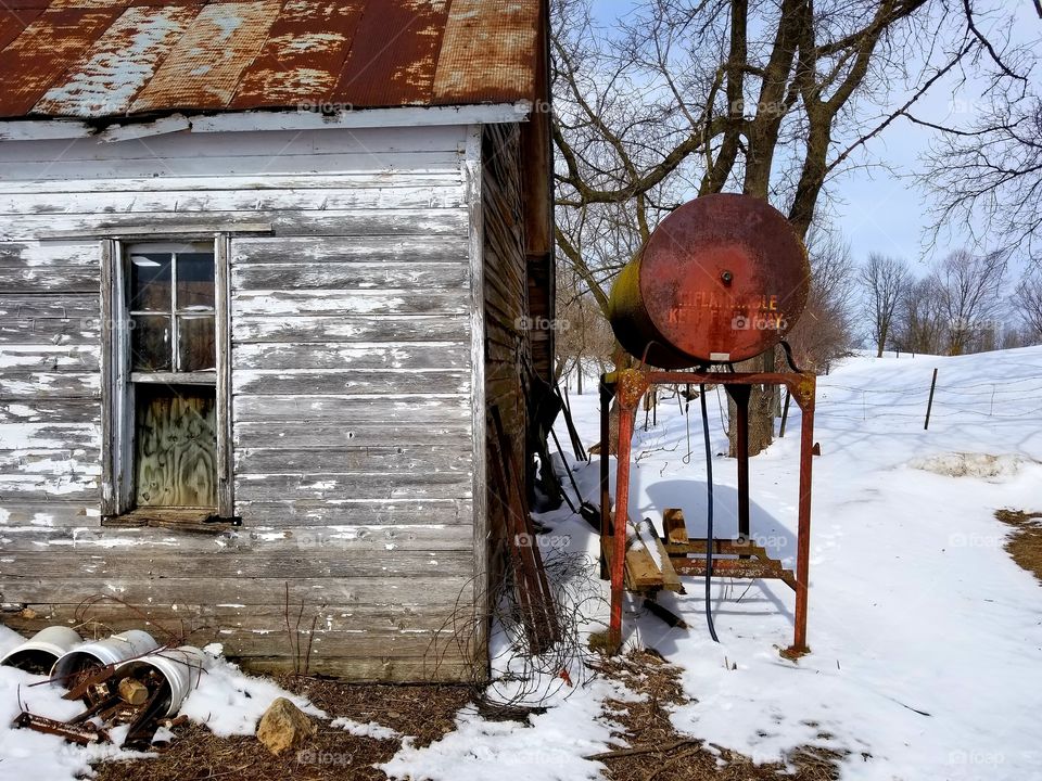 Rustic shed and fuel barrel in the country.