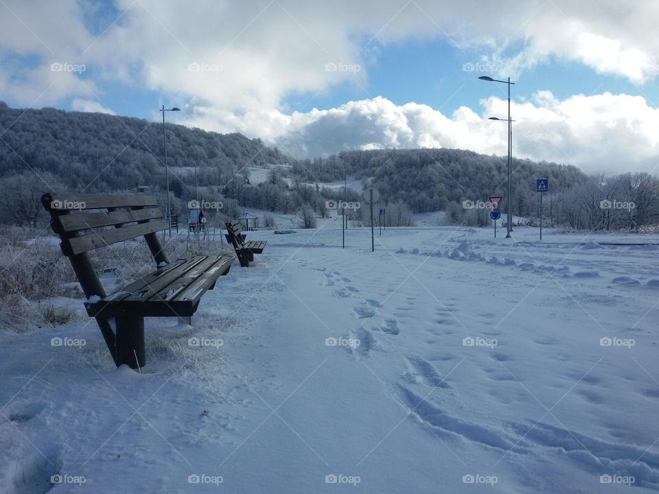 bench on mountain in winter