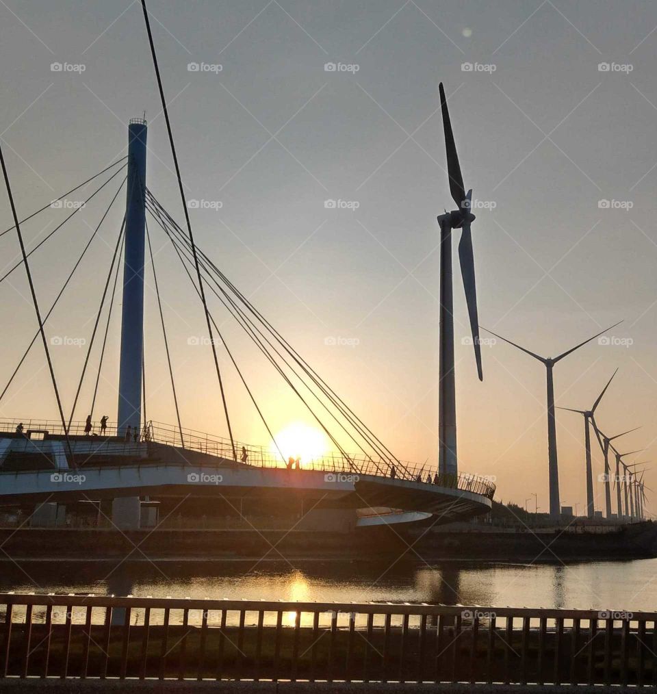 the cable-stayed bridge and windmill blvd. at sunset.