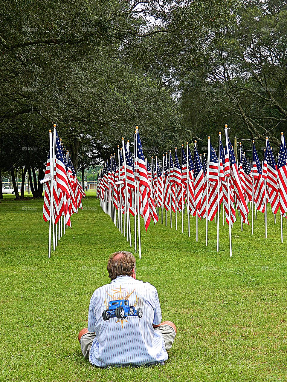 A father sits in silence wishing his deceased son was still alive, instead of a American flag that represented him. 