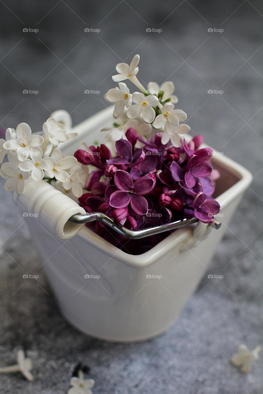 A bouquet of lilacs in a white vase