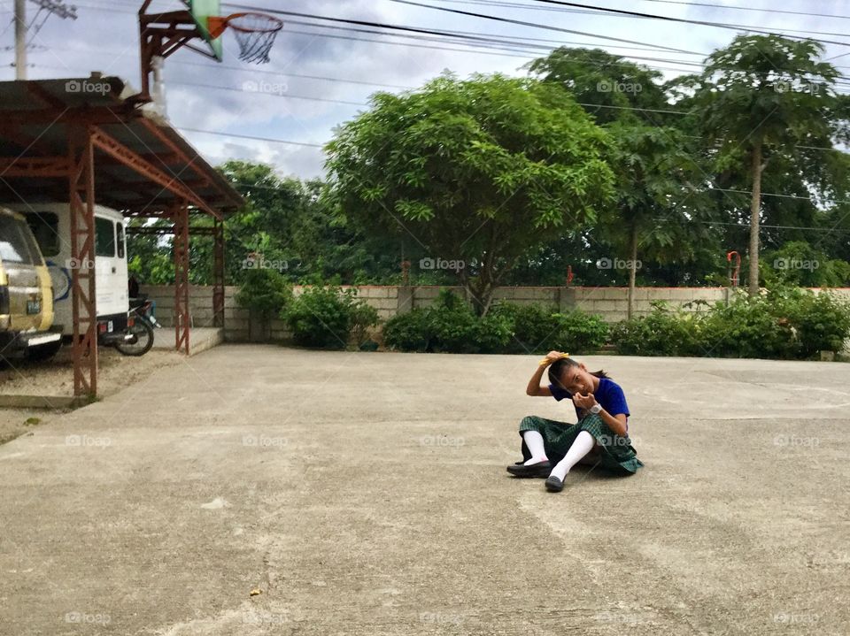 My cousin sitting on our basketball court. 🏀