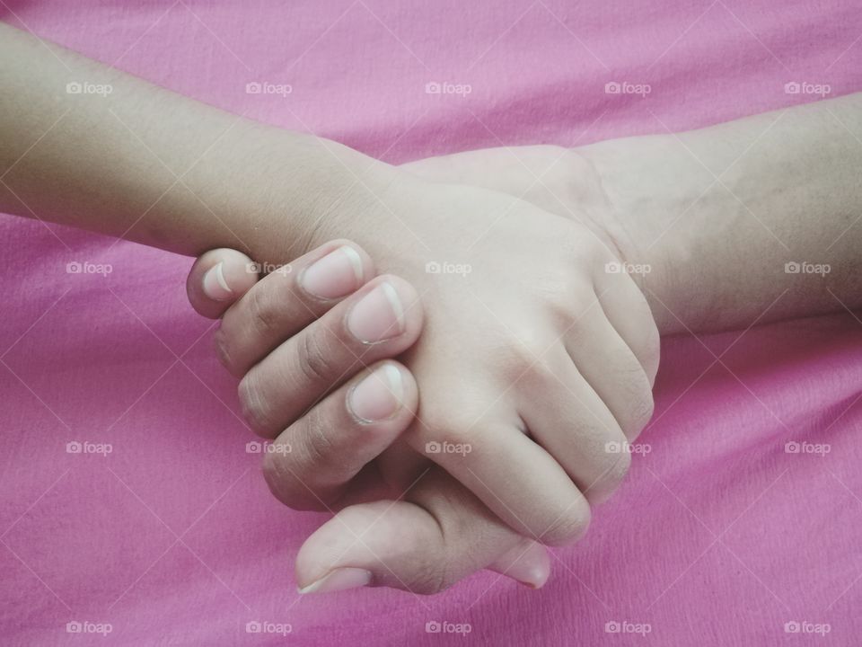 Two people holding hands