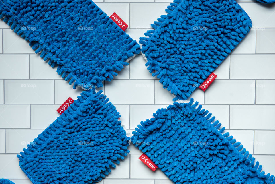 Flat lay of O-Cedar microfiber mop head refills on a tile floor