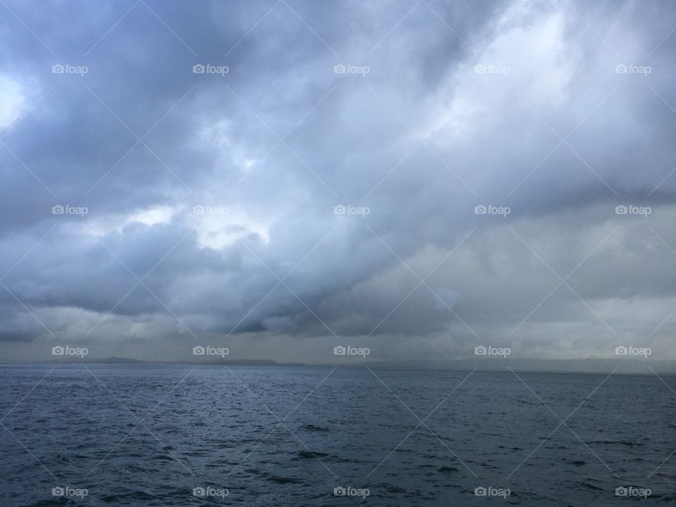 Storm clouds brewing above the ocean.