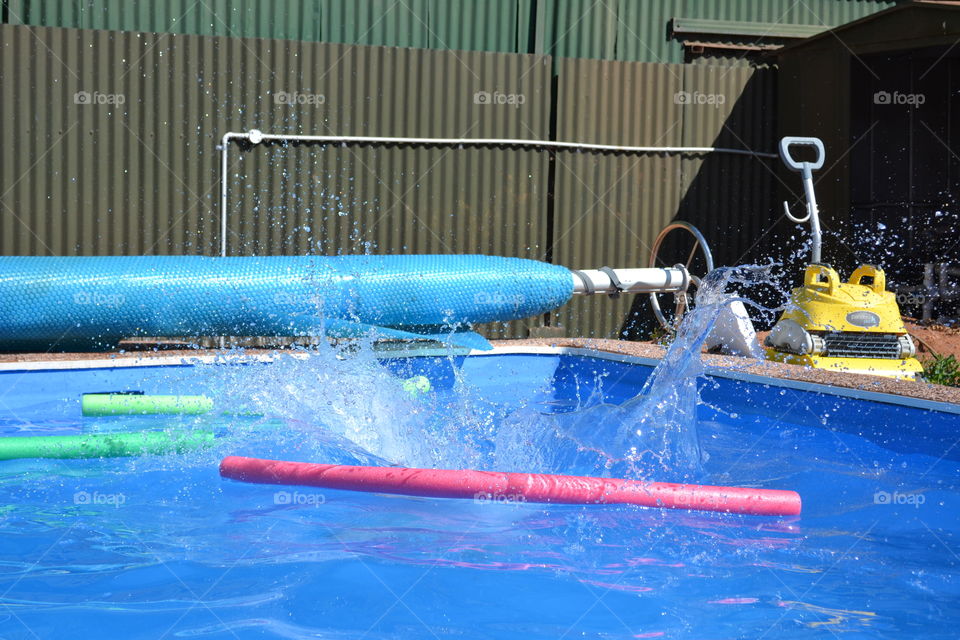 Splash of water in outdoor swimming pool