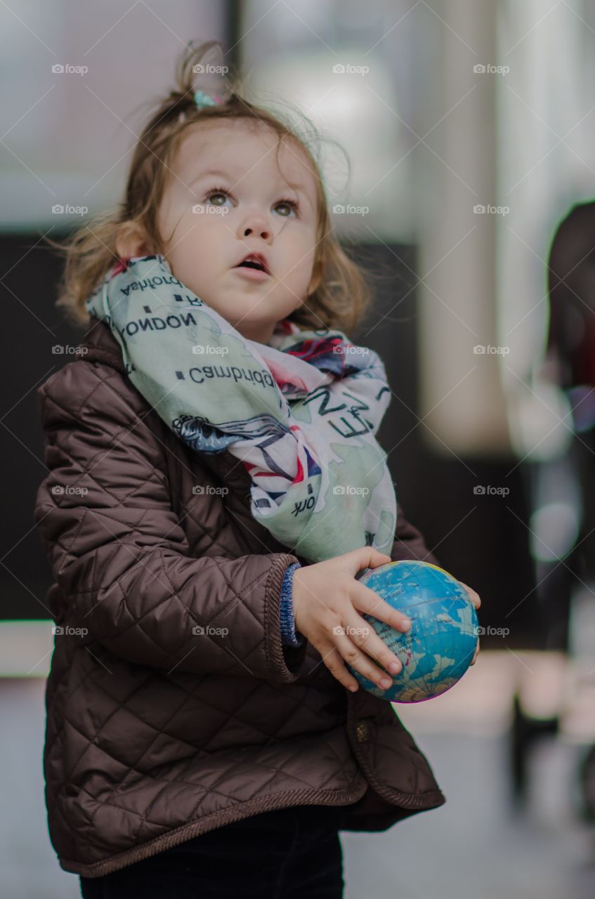 Little girl holding globe