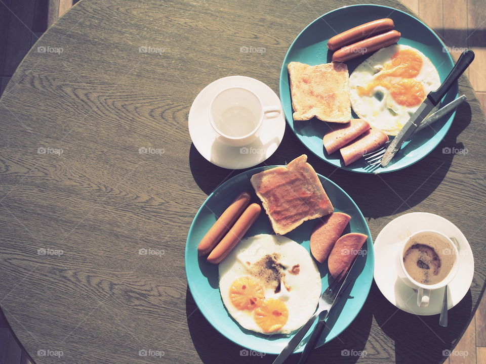 American breakfast with coffee cup top view on table and sunshine in morning