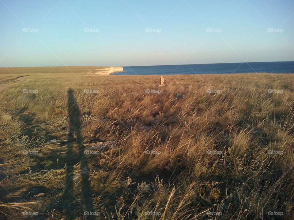 shadows people on the steppe and seascape