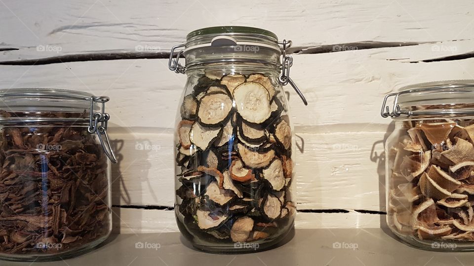 Dehydrated vegetables and mushrooms in glass jars 
