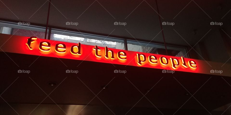 sign feed the people at restaurant credo