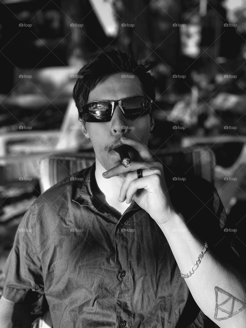 Man in sunglasses smoking cigar black and white portrait 