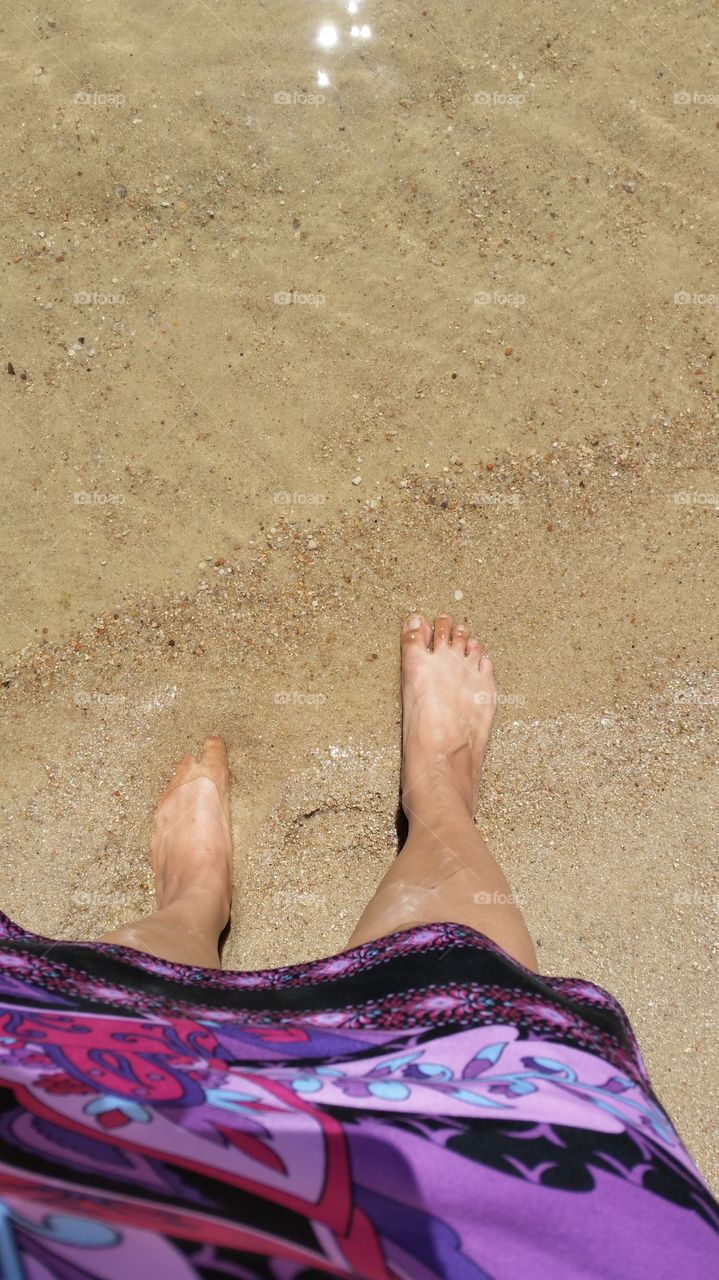 Feet walking in beach sand at Aurora Reservoir in Colorado