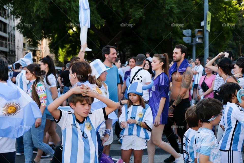 Buenos Aires - 18.12.2022: Football fans in t-shirts of the national team of Argentina celebrating victory on the street