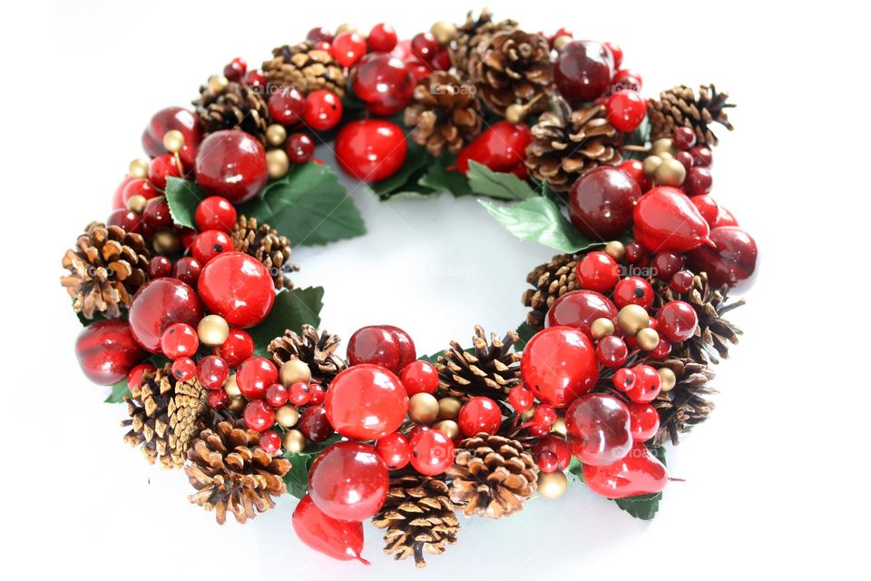 Bright red festive wreath isolated on white background