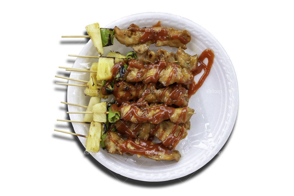 Isolated BBQ grilled Chicken with vegetables and tomato sauces on a white background with clipping path.