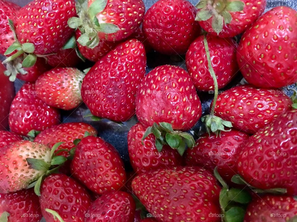 Fresh picked Red strawberries hulls on closeup 