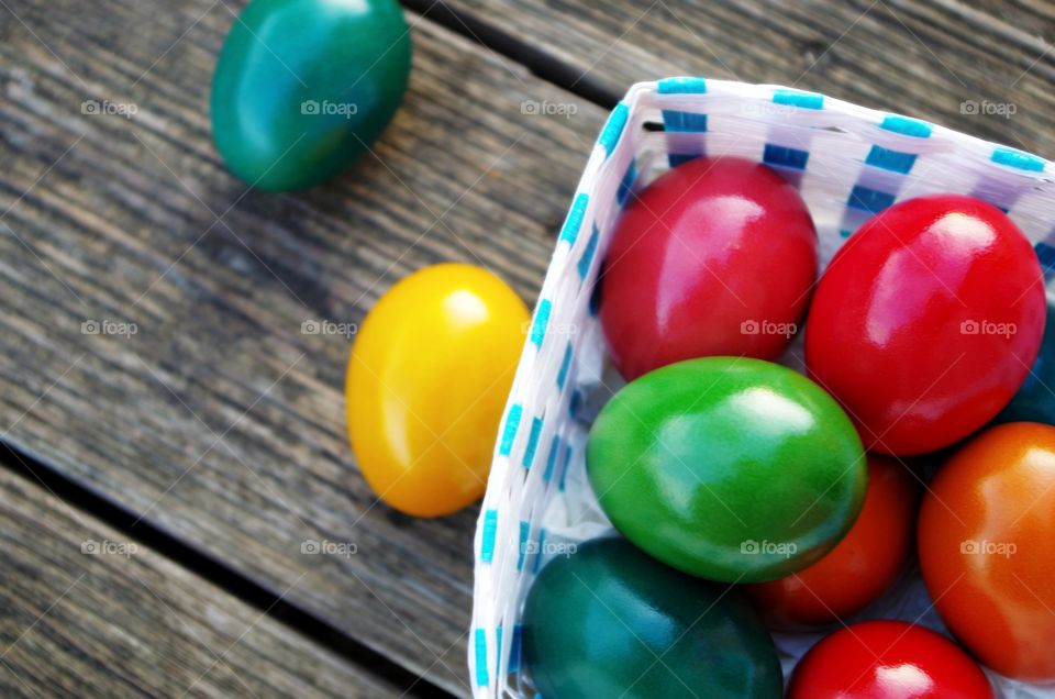 Colorful easter eggs on wooden background