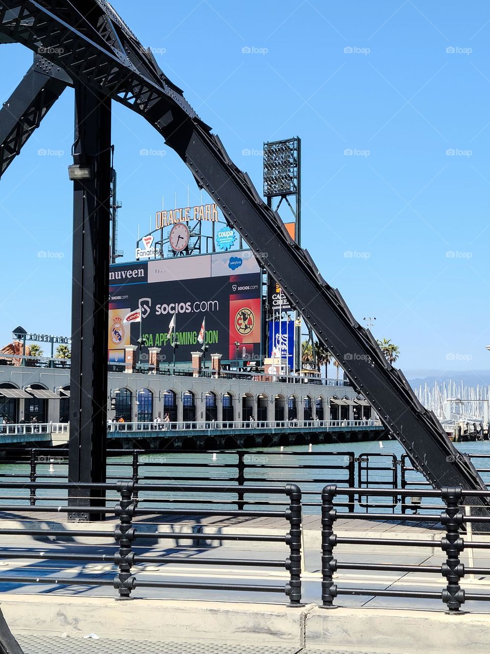 Looking through the 3rd street bridge in San Francisco California at Oracle Park on the San Francisco Bay with a little glimpse of the sailboat marina by McCovey Cove