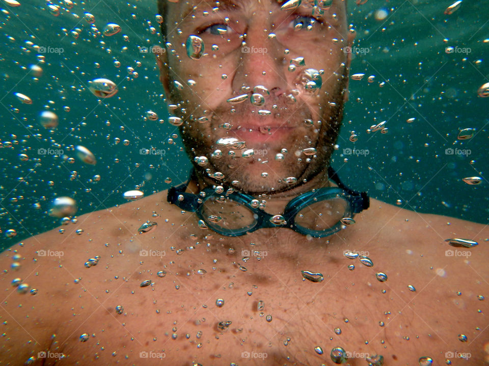 bubbles in water. man among bubbles underwater