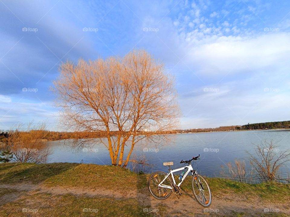 one bike on a lake shore beautiful nature landscape blue sky background