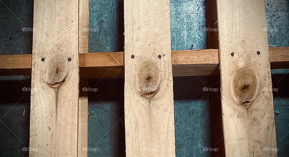 These happy face’s caught my eye at work. Nails and knots spear to be smiley faces. 