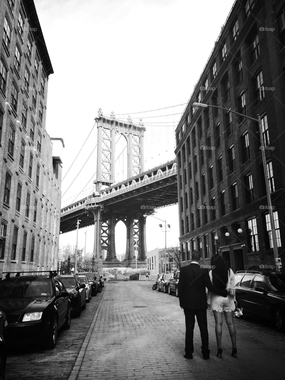 Passionate couple stares at Brooklyn Bridge from Washington Street 