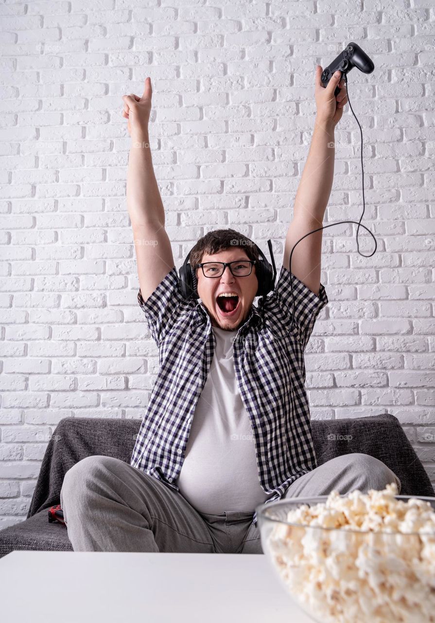 young emotional man playing video games