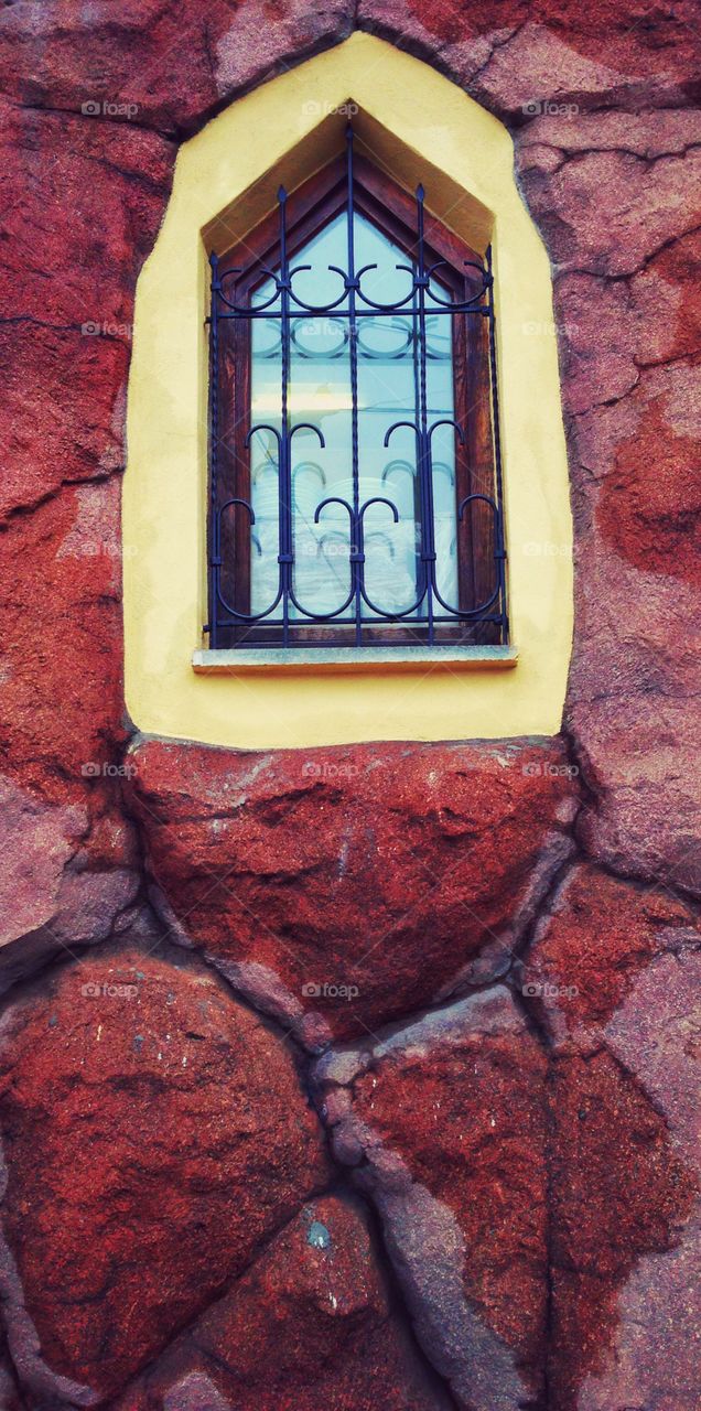 Bright window on rustic wall