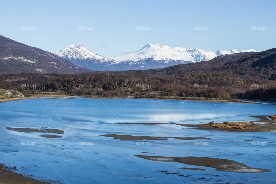landscape of snowy mountains and lake