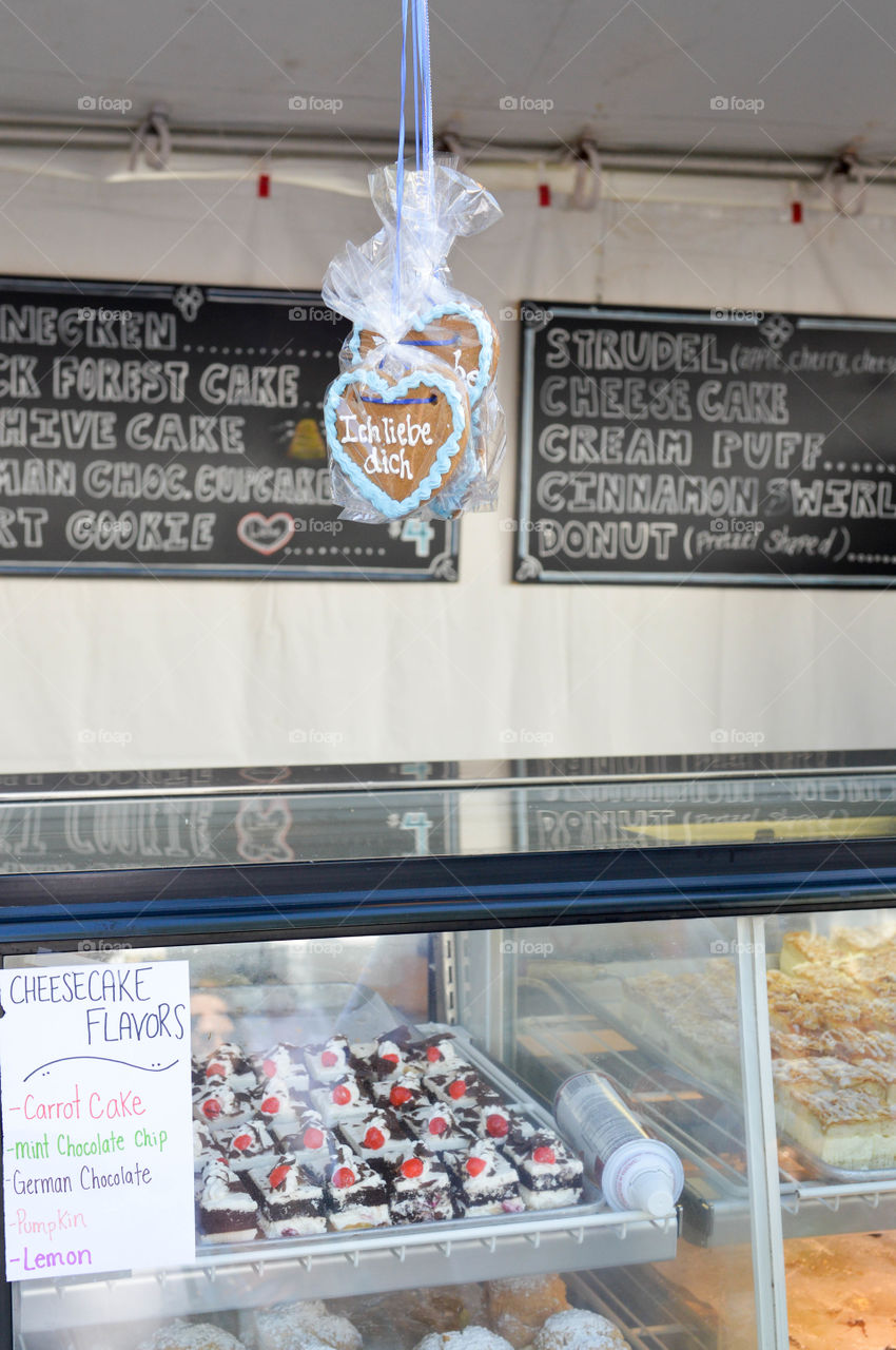 German bakery case full of sweets with hanging cookies at a festival