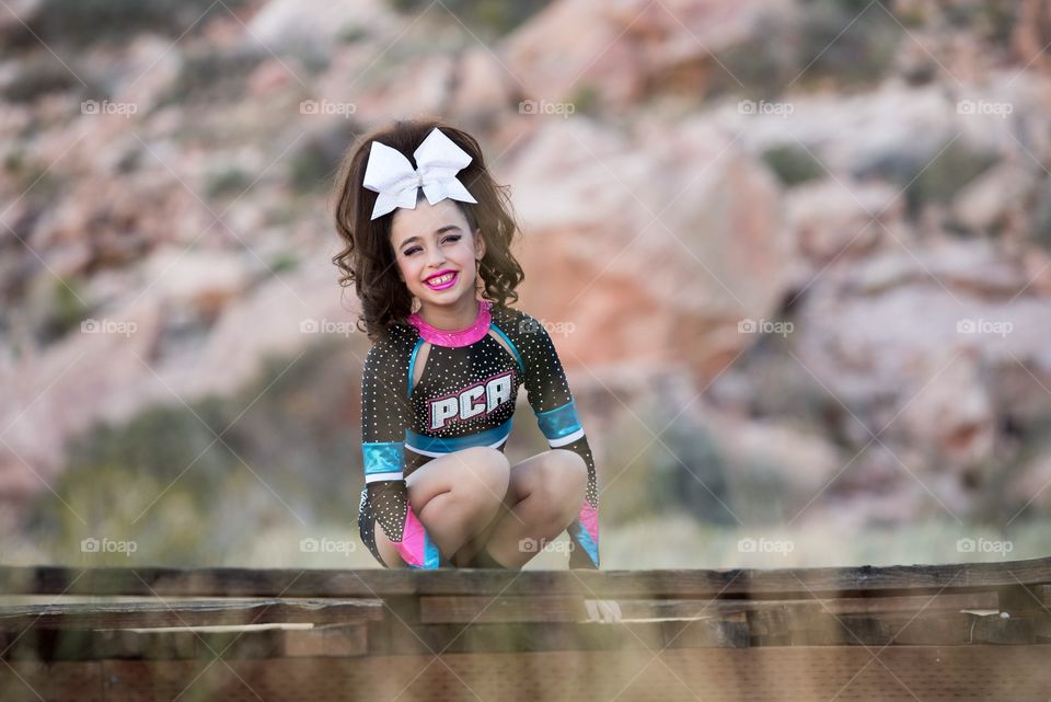 Young cheerleader girl at red Rock mountains