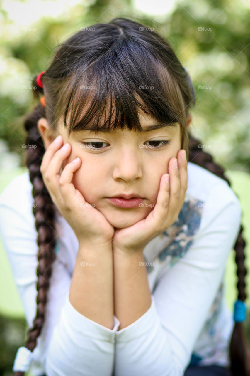 Thoughtful little girl outdoors