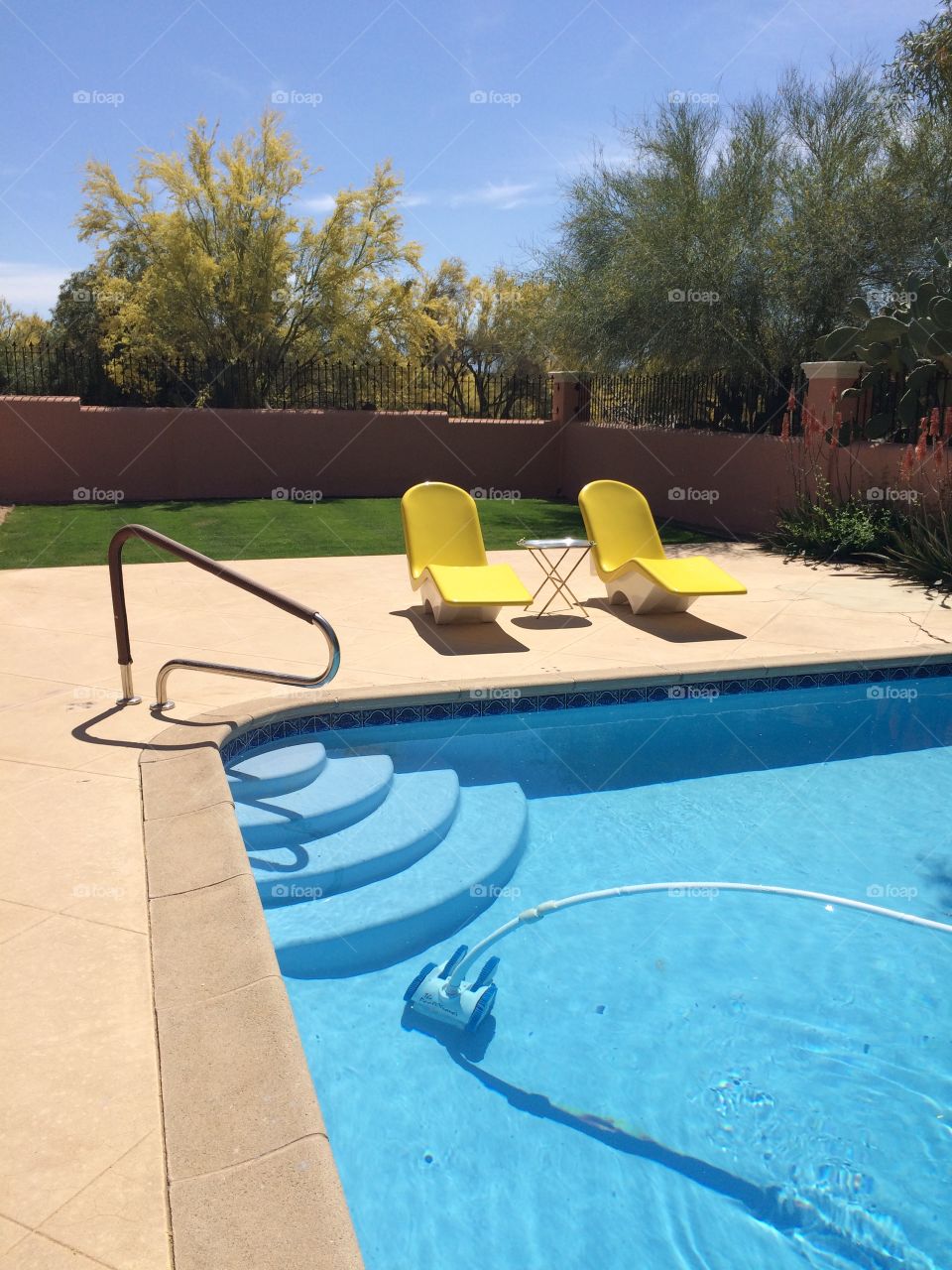 Poolside in the Desert. Yellow chairs by the pool