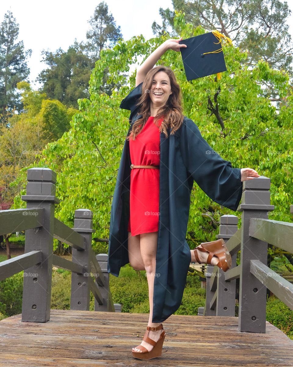 Happy woman with graduation gown and hat